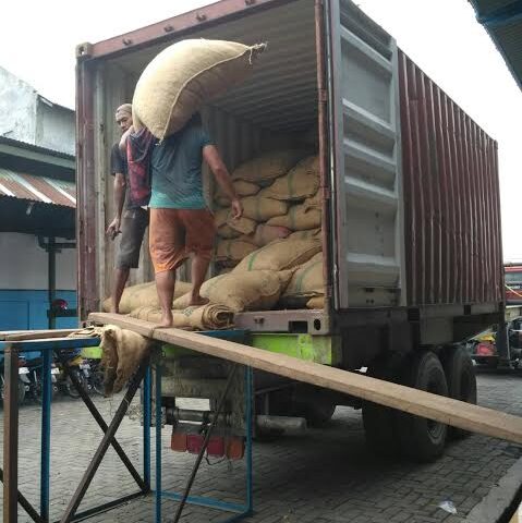 Workers Loading Sacks from Truck Container